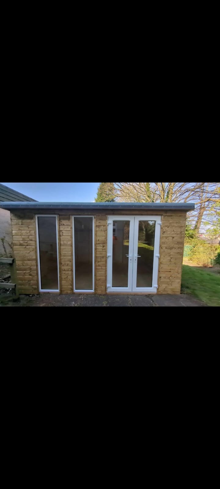 Premium 10×8 pressure-treated timber shed installed in an Edinburgh garden on a concrete pad