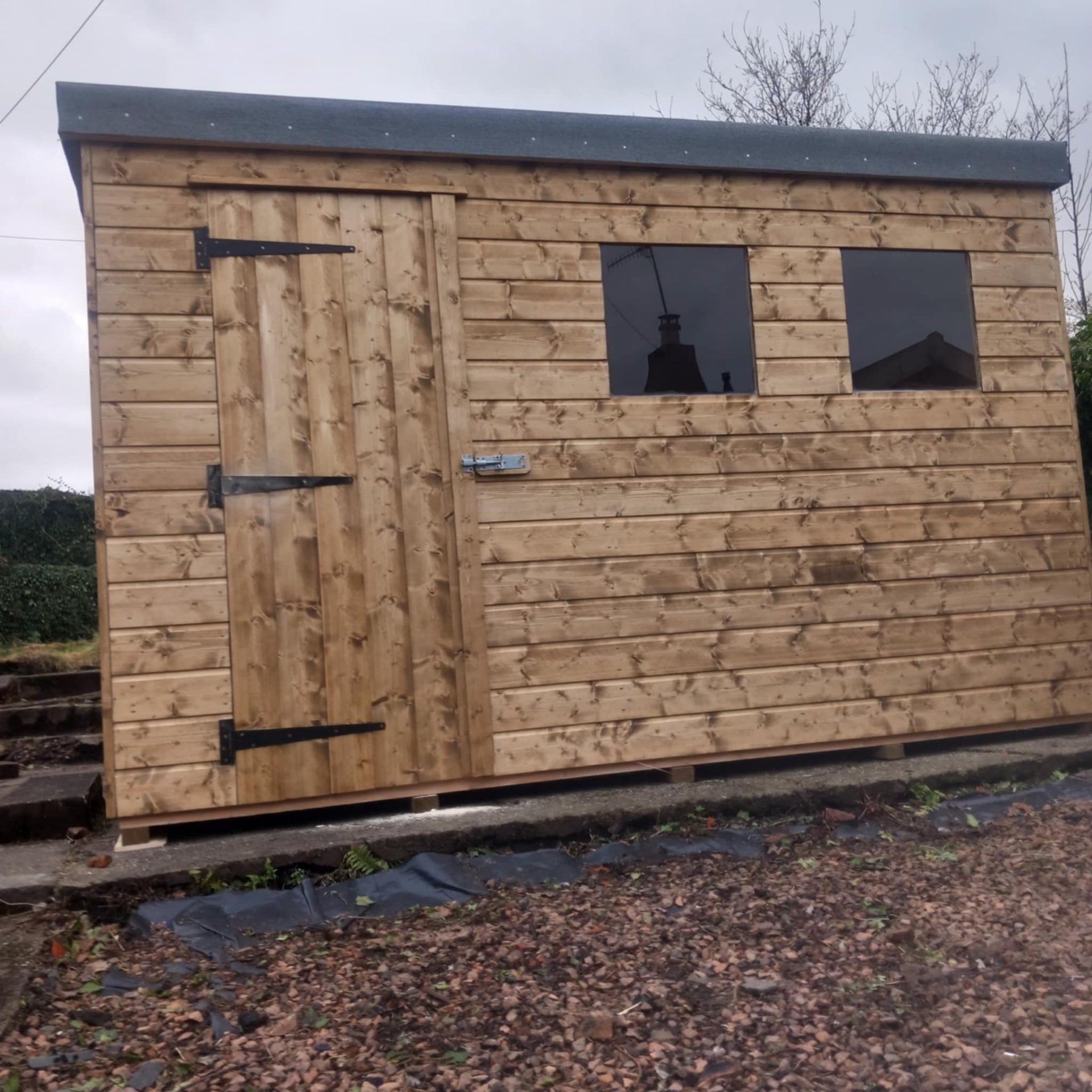 Eight by six foot pressure-treated shiplap storage shed with single window and security lock fitted in Musselburgh East Lothian